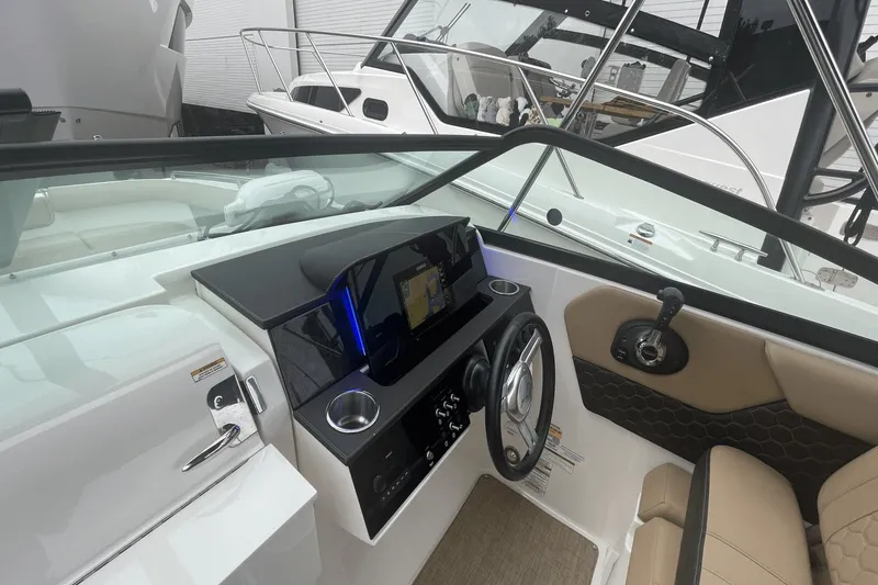 Slide: The Image of 2019 Sea Ray SDX 250 Outboard boat interior with steering wheel and control panel. - 34