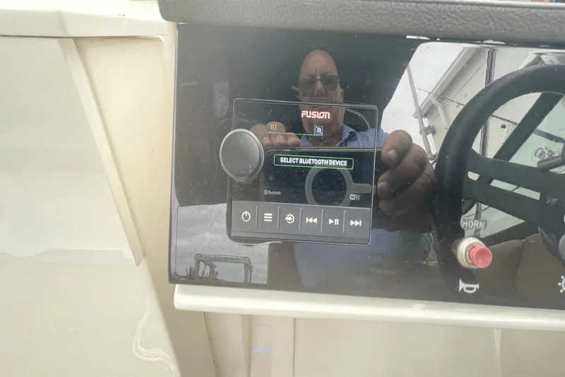 Slide: The Image of Control panel of 2019 Sea Ray SDX 250 Outboard with Bluetooth device selection. - 35