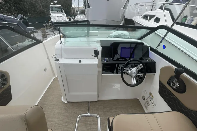 Slide: The Image of 2019 Sea Ray SDX 250 Outboard boat interior with steering wheel and control panel. - 36