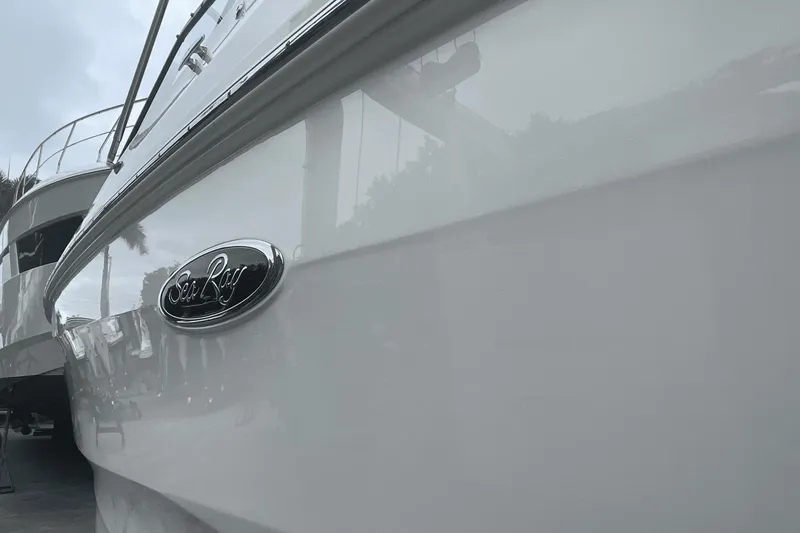 Slide: The Image of 2019 Sea Ray SDX 250 Outboard boat, close-up view of sleek hull and logo. - 9