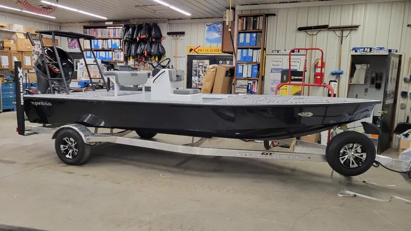 The Image of 2025 Xpress Skiff 185 with Yamaha Vmax 115 SHO in stock, displayed indoors. - 1