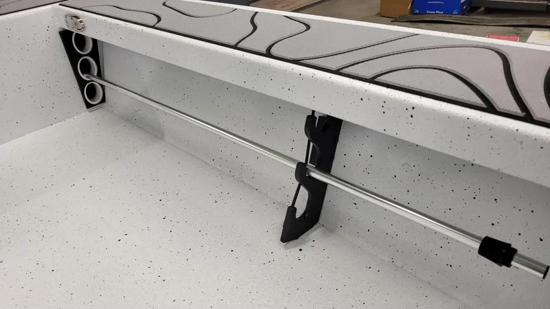 Slide: The Image of 2025 Xpress Skiff 185 interior with rod holders and speckled finish. - 10