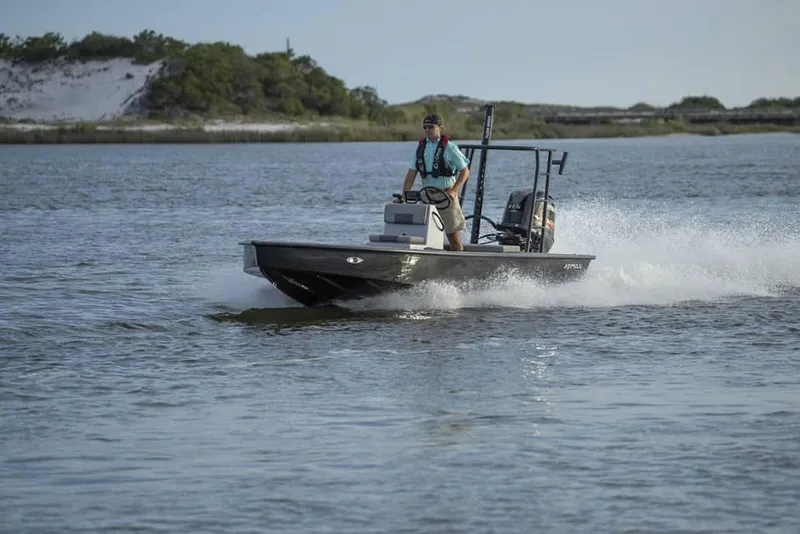 Slide: The Image of 2025 Xpress Skiff 185 with Yamaha Vmax 115 SHO speeding on water. - 13