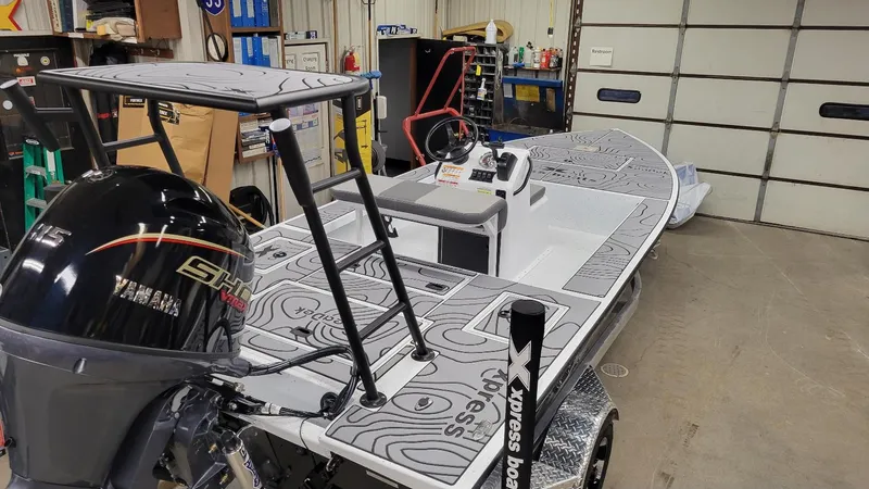 Slide: The Image of 2025 Xpress Skiff 185 with Yamaha Vmax 115 SHO in a garage setting. - 16