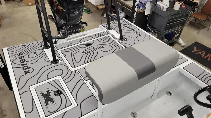 Slide: The Image of 2025 Xpress Skiff 185 boat interior with Yamaha Vmax 115 SHO engine, featuring custom Seadek flooring. - 19