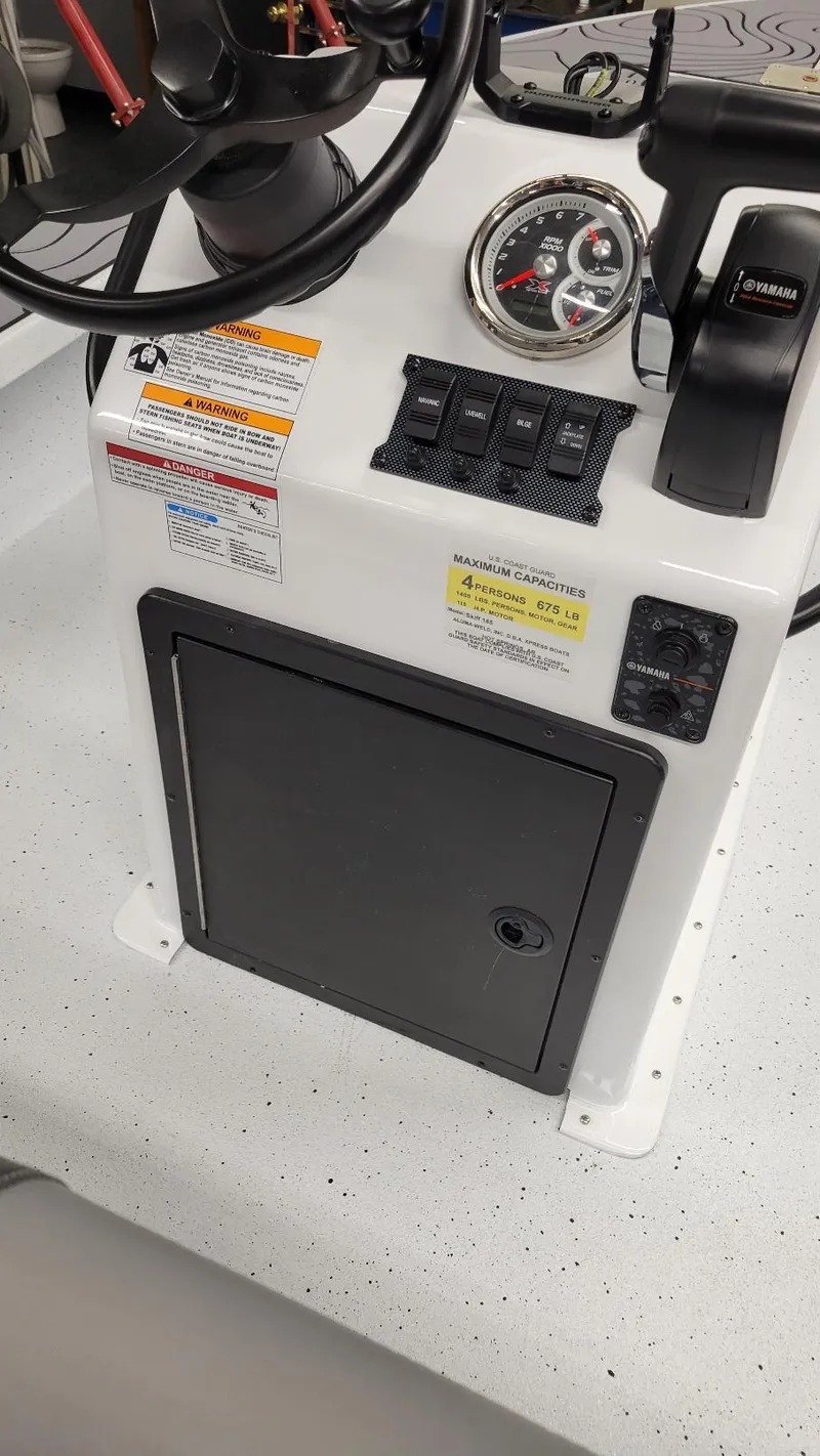 Slide: The Image of 2025 Xpress Skiff 185 console with Yamaha Vmax 115 SHO controls and gauges. - 21