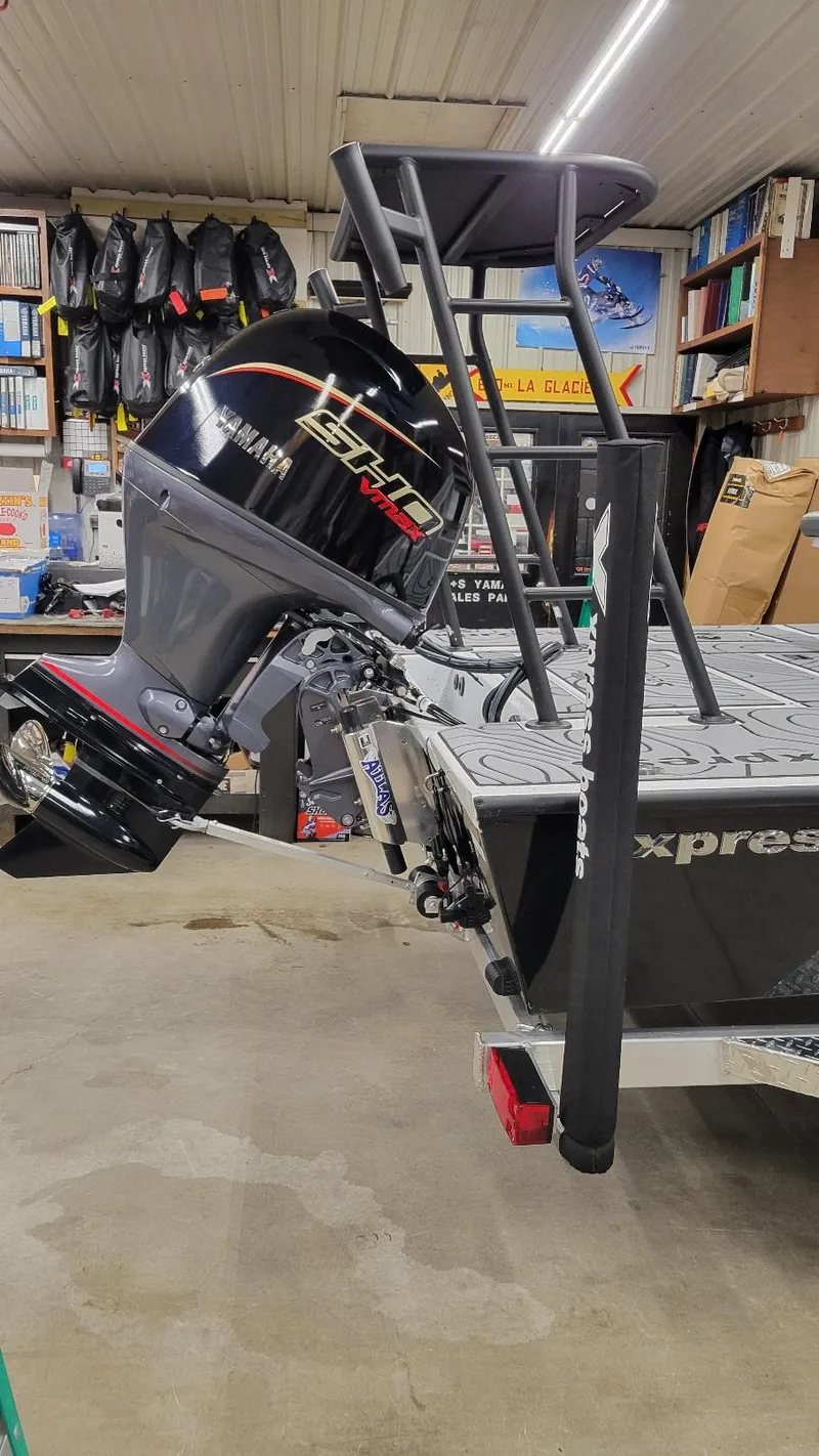 Slide: The Image of 2025 Xpress Skiff 185 with Yamaha Vmax 115 SHO engine in a garage setting. - 3