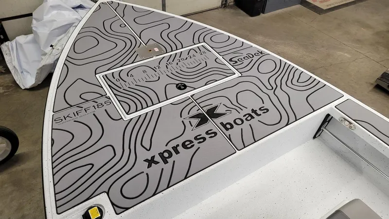 Slide: The Image of 2025 Xpress Skiff 185 boat deck with custom SeaDek design and measurement guide. - 5