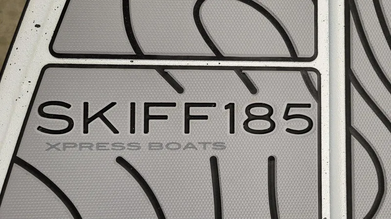 Slide: The Image of Xpress Skiff 185 boat floor detail, showcasing brand and model name. - 7