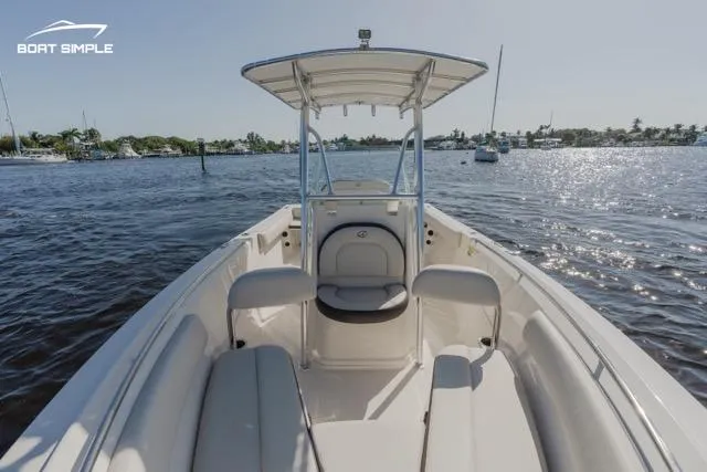 Slide: The Image of 2023 Sailfish 220 CC boat on calm waters with clear skies. - 5