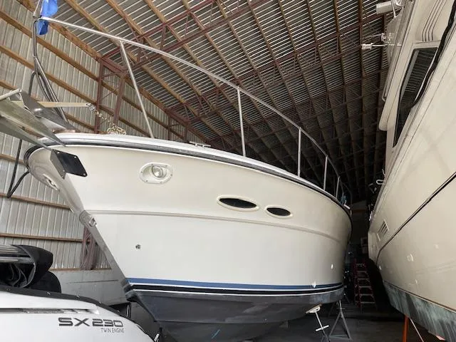 Slide: The Image of 1989 Sea Ray 390 Express Cruiser stored in a covered boat shed. - 21