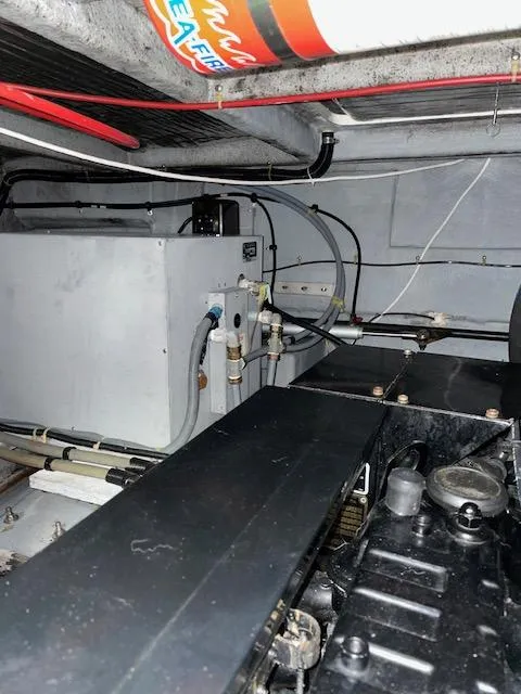 Slide: The Image of Engine room of 1989 Sea Ray 390 Express Cruiser, showcasing mechanical components and wiring. - 31