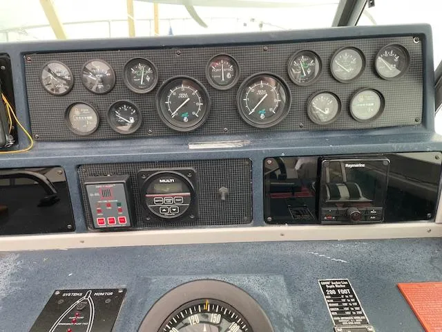 Slide: The Image of Dashboard of a 1989 Sea Ray 390 Express Cruiser with gauges and navigation equipment. - 34