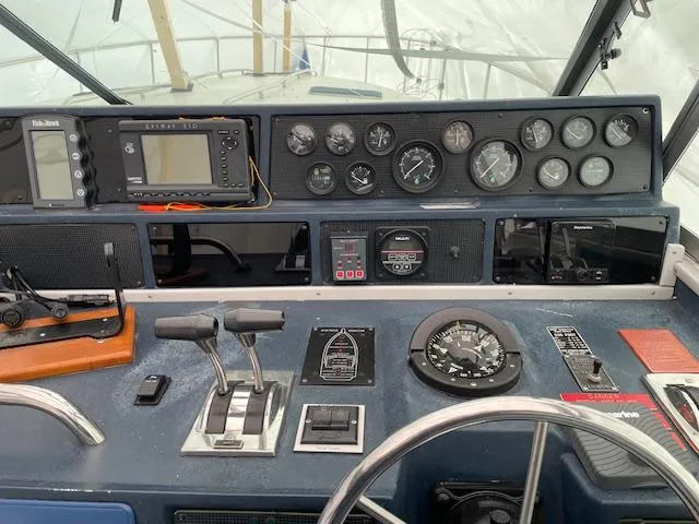 Slide: The Image of Control panel of a 1989 Sea Ray 390 Express Cruiser with gauges and navigation equipment. - 35