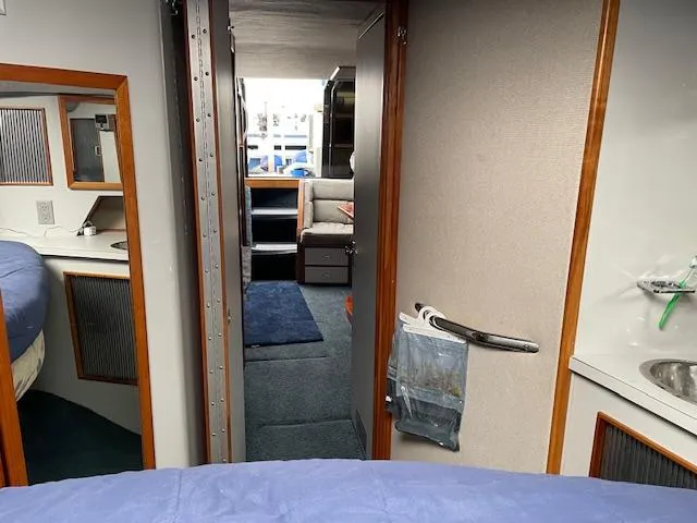 Slide: The Image of Interior of 1989 Sea Ray 390 Express Cruiser, featuring cozy cabin and seating area. - 37