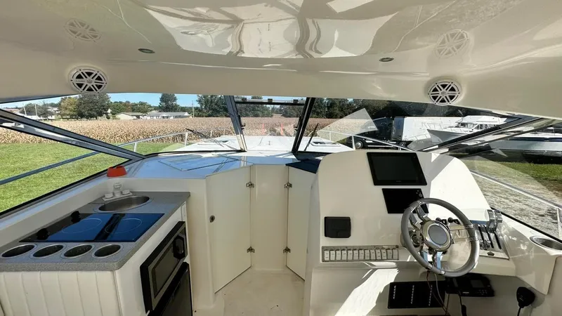 Slide: The Image of Interior of a 2009 Eliminator 47' Cat boat with modern helm and kitchenette. - 5