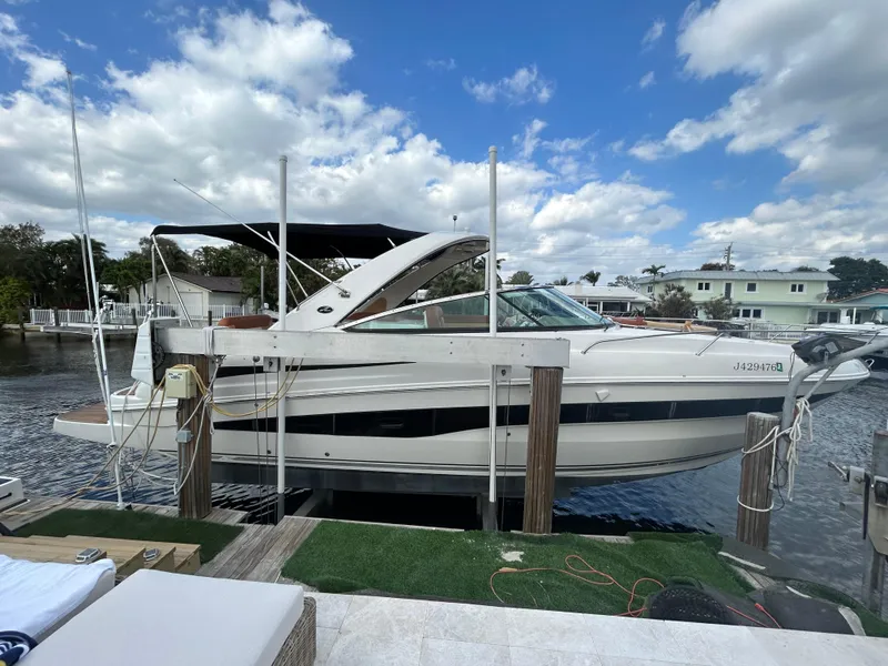 Slide: The Image of 2014 Sea Ray 370 Venture docked at a marina under a partly cloudy sky. - 11