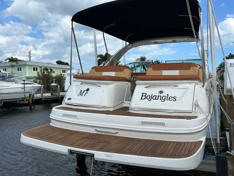Slide: The Image of 2014 Sea Ray 370 Venture boat docked with Bojangles and M! names on the stern. - 13