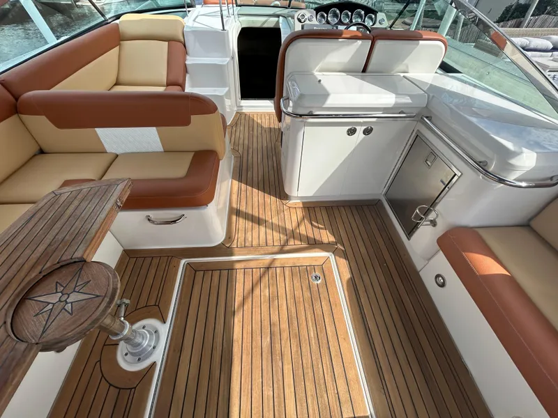 Slide: The Image of 2014 Sea Ray 370 Venture boat interior with teak flooring and cushioned seating. - 15