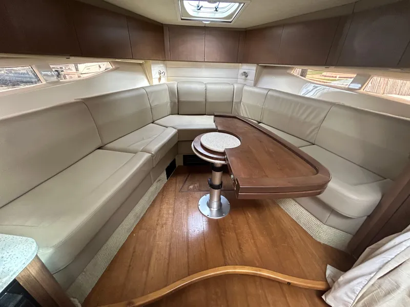 Slide: The Image of Luxurious interior of 2014 Sea Ray 370 Venture with spacious seating and wooden table. - 18