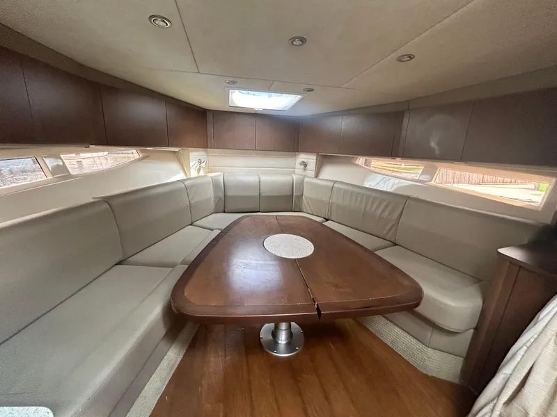 Slide: The Image of Luxurious interior of 2014 Sea Ray 370 Venture with spacious seating and wooden table. - 26