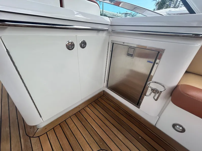 Slide: The Image of Sea Ray 370 Venture 2014 boat interior with wooden flooring and stainless steel fixtures. - 30