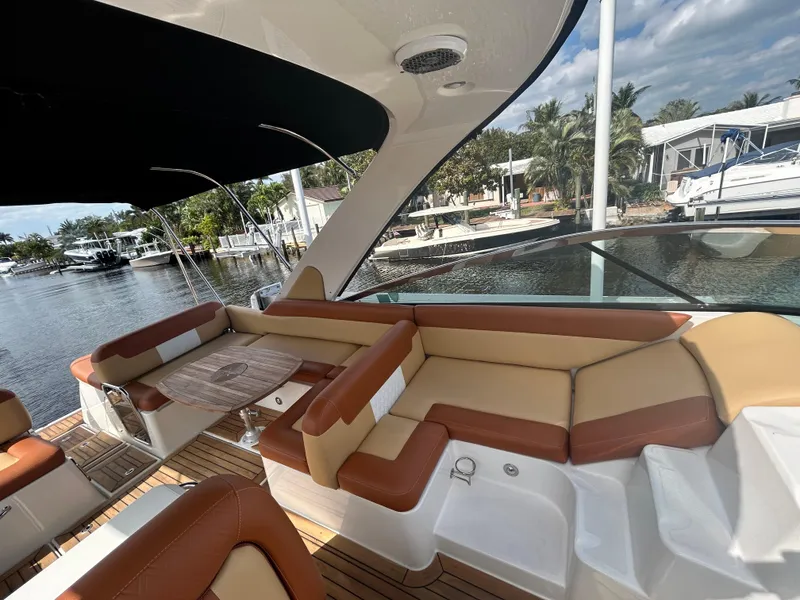 Slide: The Image of 2014 Sea Ray 370 Venture yacht with spacious seating area and waterfront view. - 33