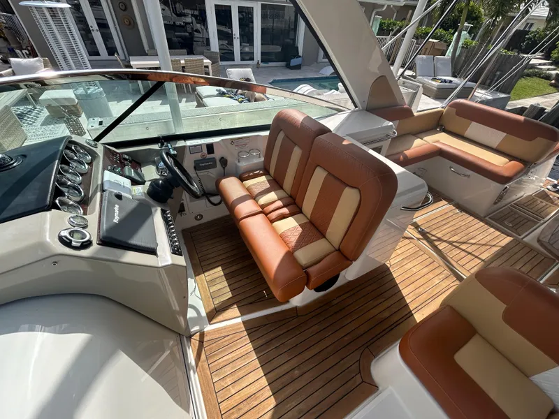 Slide: The Image of 2014 Sea Ray 370 Venture boat interior with tan and brown seating. - 34