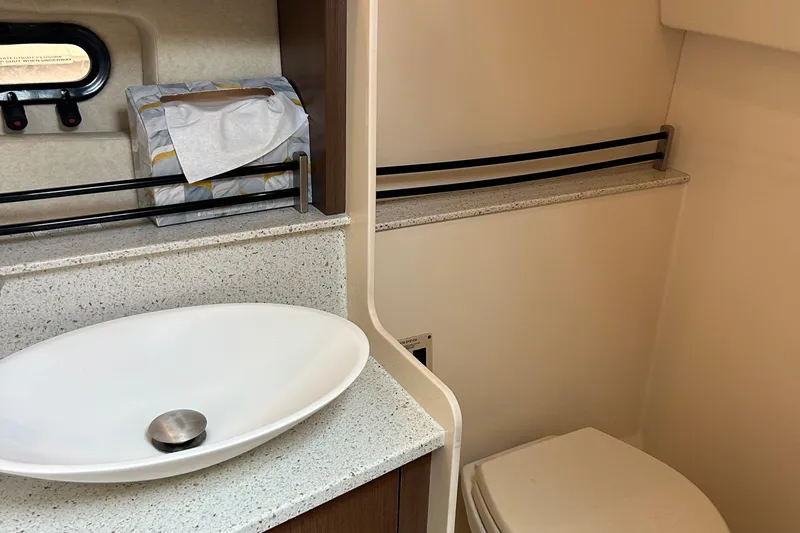 Slide: The Image of 2014 Sea Ray 370 Venture bathroom with modern sink and toilet. - 44