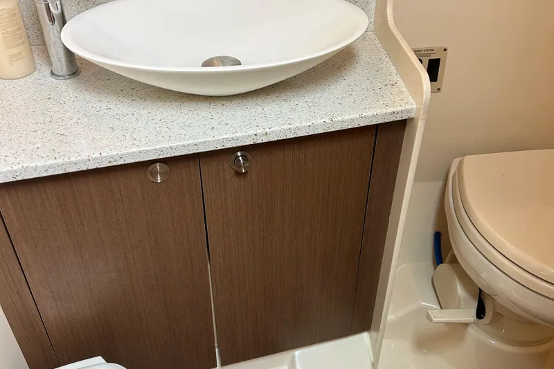 Slide: The Image of 2014 Sea Ray 370 Venture bathroom with modern sink and toilet. - 45