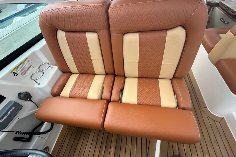 Slide: The Image of 2014 Sea Ray 370 Venture boat with tan and beige cushioned seats. - 47