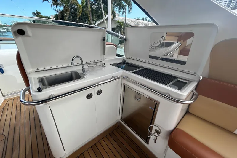 Slide: The Image of 2014 Sea Ray 370 Venture yacht kitchenette with sink, grill, and storage. - 49