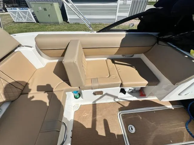 Slide: The Image of 2023 Bayliner DX 2050 boat interior with tan seating and storage compartments. - 11