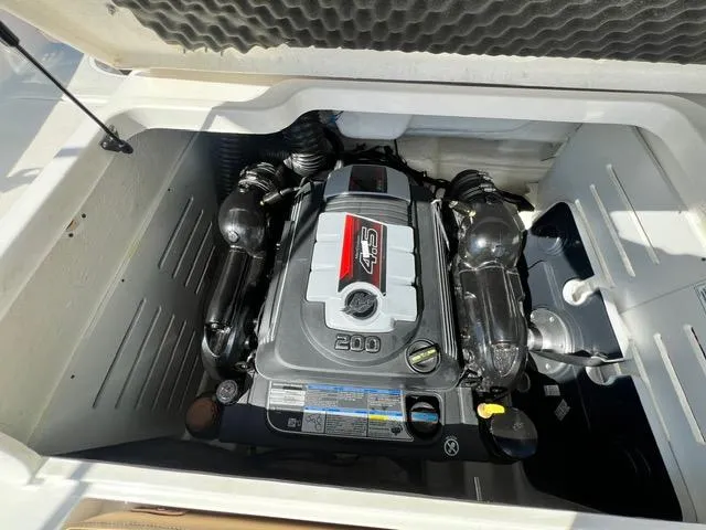 Slide: The Image of 2023 Bayliner DX 2050 boat engine compartment with 4.5L 200 HP engine. - 12