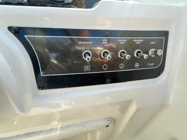 Slide: The Image of Control panel of a 2023 Bayliner DX 2050 boat with switches for lights and horn. - 18