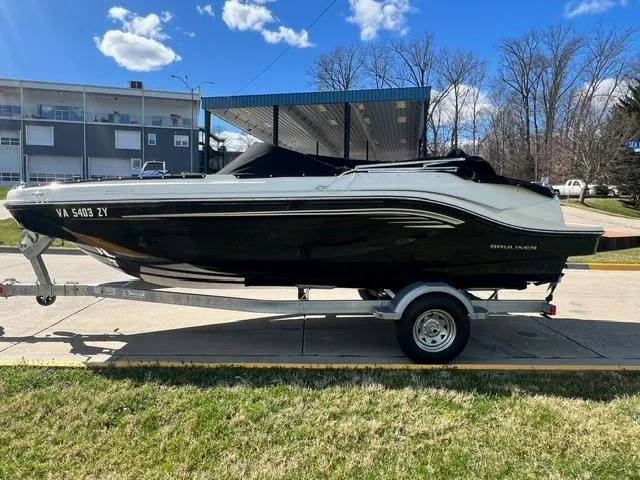 Slide: The Image of 2023 Bayliner DX 2050 boat on trailer, parked outdoors. - 4