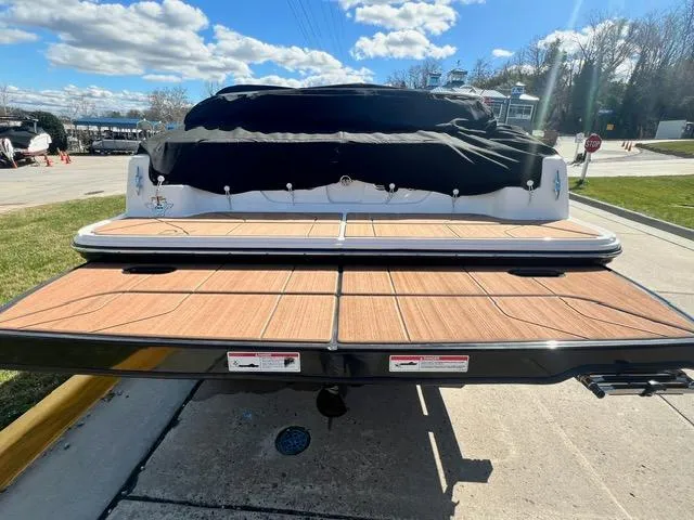 Slide: The Image of 2023 Bayliner DX 2050 boat with covered deck at a marina. - 7