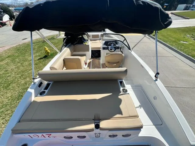 Slide: The Image of 2023 Bayliner DX 2050 boat with beige seating and black canopy. - 8