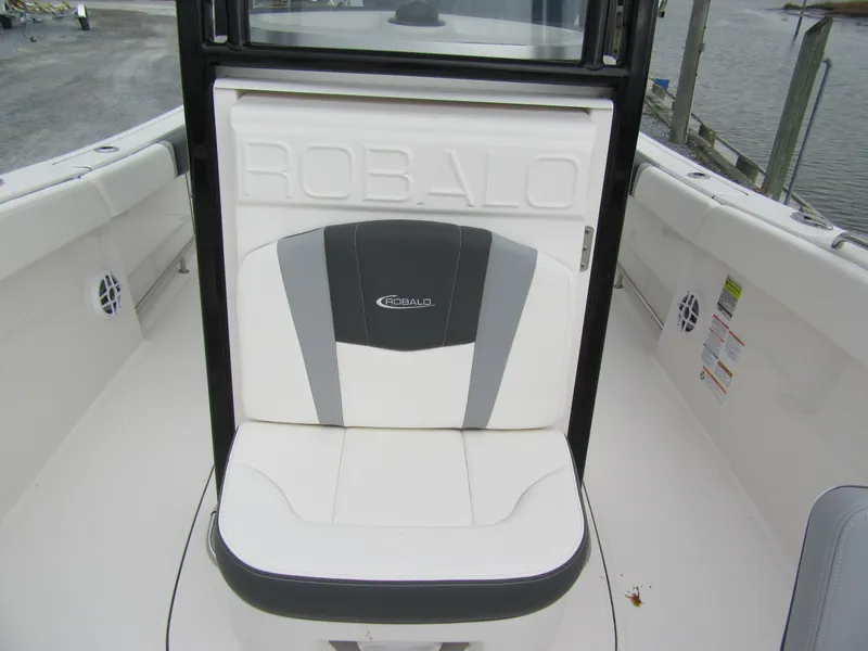 Slide: The Image of 2024 Robalo R230 Center Console boat seat with logo, white and gray design. - 11