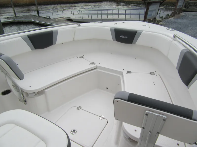 Slide: The Image of 2024 Robalo R230 Center Console boat interior with cushioned seating and storage compartments. - 12