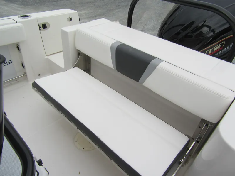 Slide: The Image of 2024 Robalo R230 Center Console boat with white cushioned seating. - 14