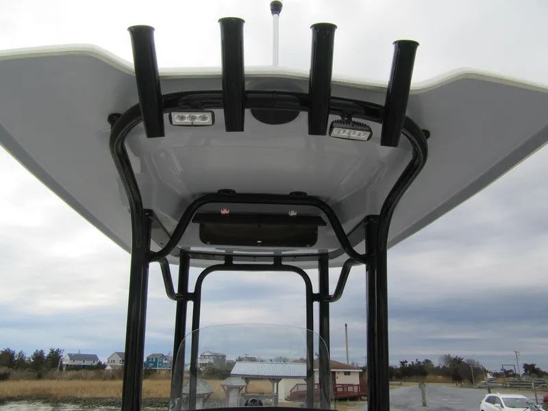Slide: The Image of 2024 Robalo R230 Center Console boat's T-top with rod holders and lights. - 7