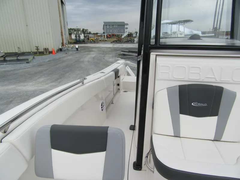 Slide: The Image of 2024 Robalo R230 Center Console boat interior with seating and console view. - 9