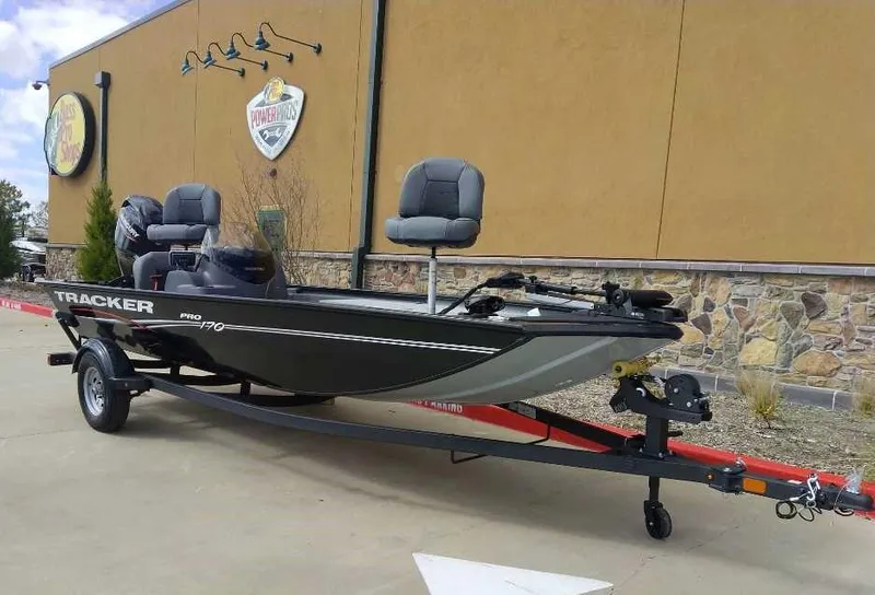 Slide: The Image of 2024 Tracker Pro 170 fishing boat on a trailer outside a building. - 5
