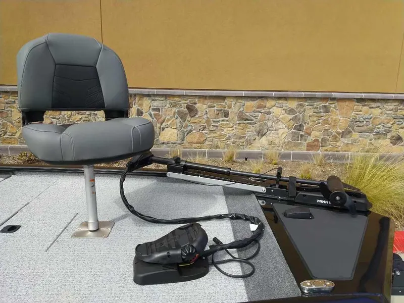 Slide: The Image of 2024 Tracker Pro 170 boat with a mounted fishing seat and trolling motor. - 6