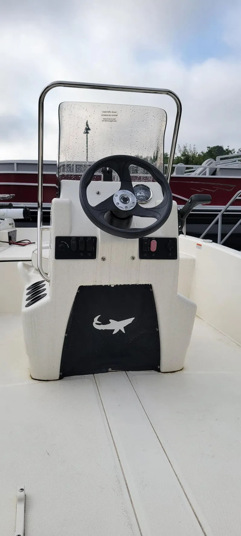Slide: The Image of 2024 Mako Pro Skiff 15 CC boat console with steering wheel and controls. - 3