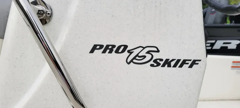 Slide: The Image of 2024 Mako Pro Skiff 15 CC logo on white boat surface. - 4