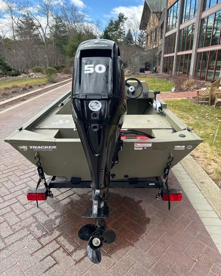 Slide: The Image of 2024 Tracker Grizzly 1648 SC boat with 50 HP Mercury engine, rear view. - 3