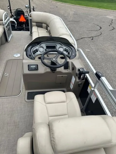 Slide: The Image of 2023 Sun Tracker Party Barge 22 XP3 interior with steering console and seating. - 2