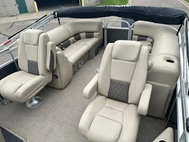 Slide: The Image of 2023 Sun Tracker Party Barge 22 XP3 interior with beige seating and spacious layout. - 3